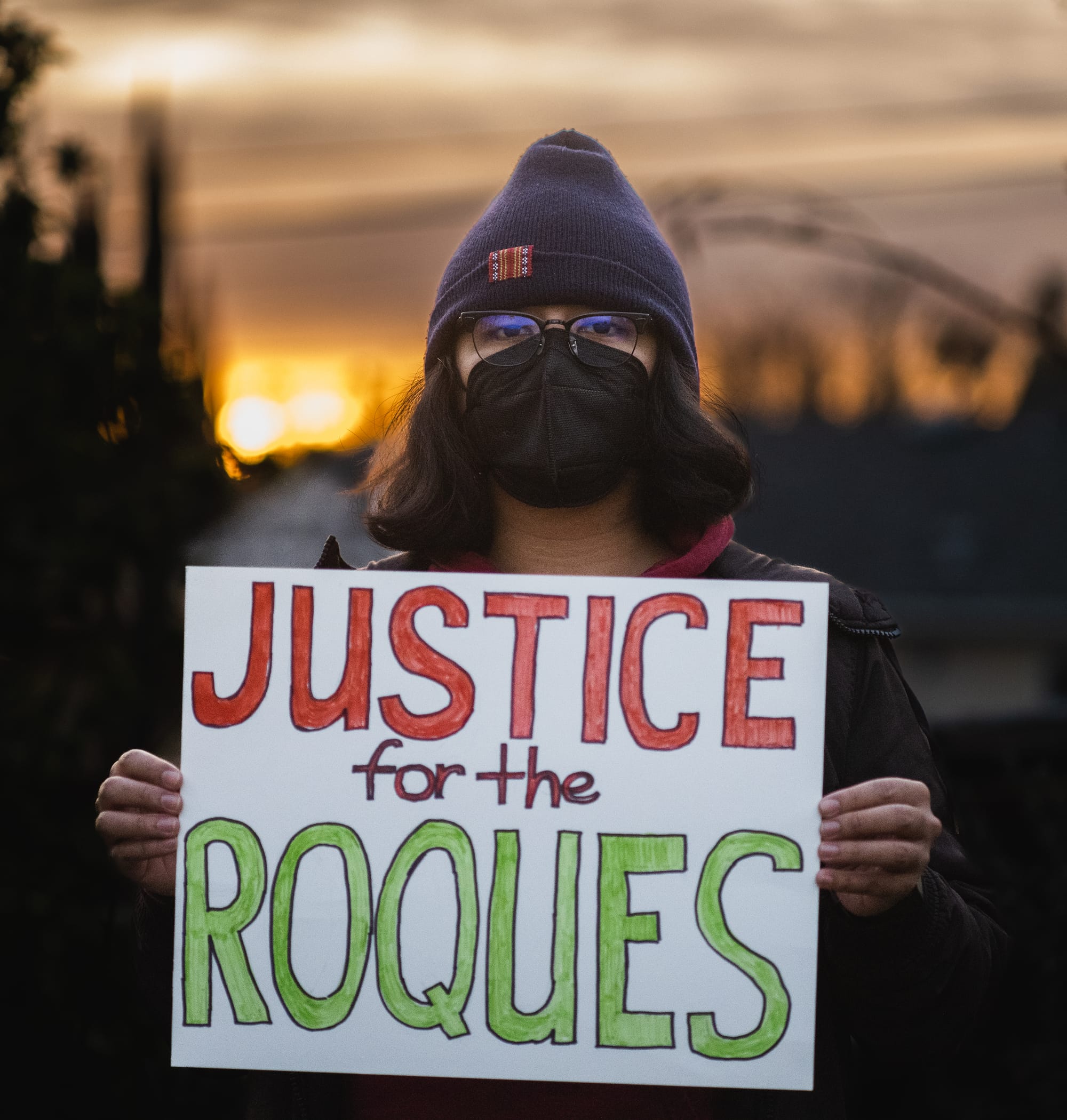 Lorenzo holding a sign that reads Justice for the Roques
