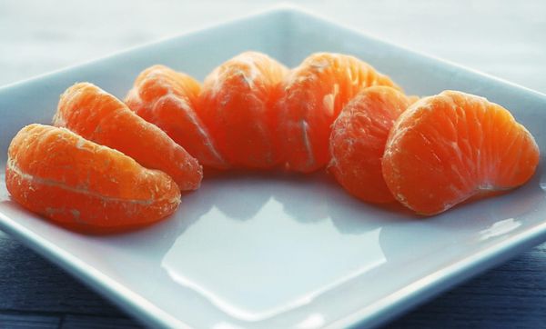 Peeled slices of mandarin orange on a white plate