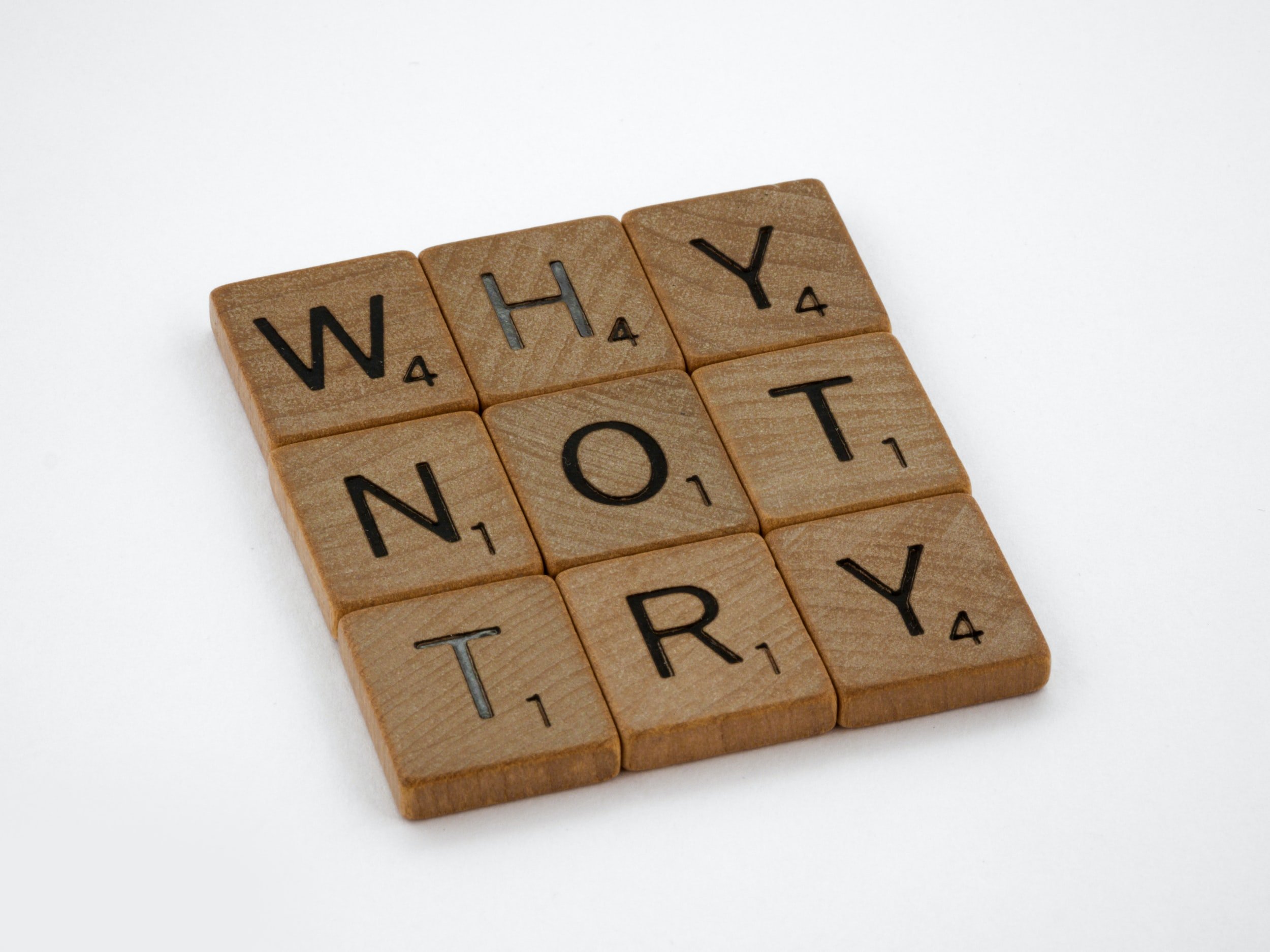 "Why Not Try?" is written in wooden letter tiles.