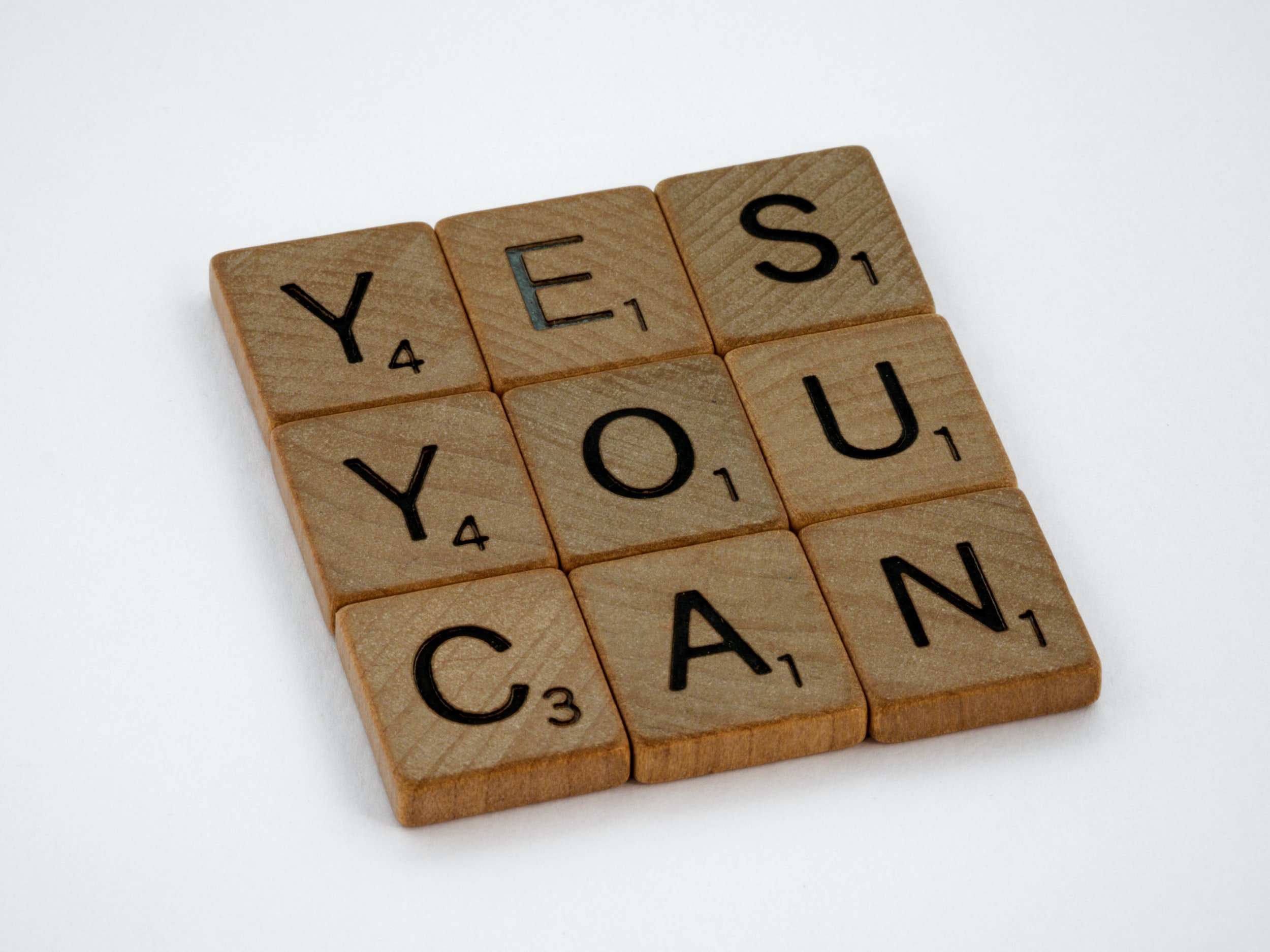 "Yes You Can" is written in wooden letter tiles.