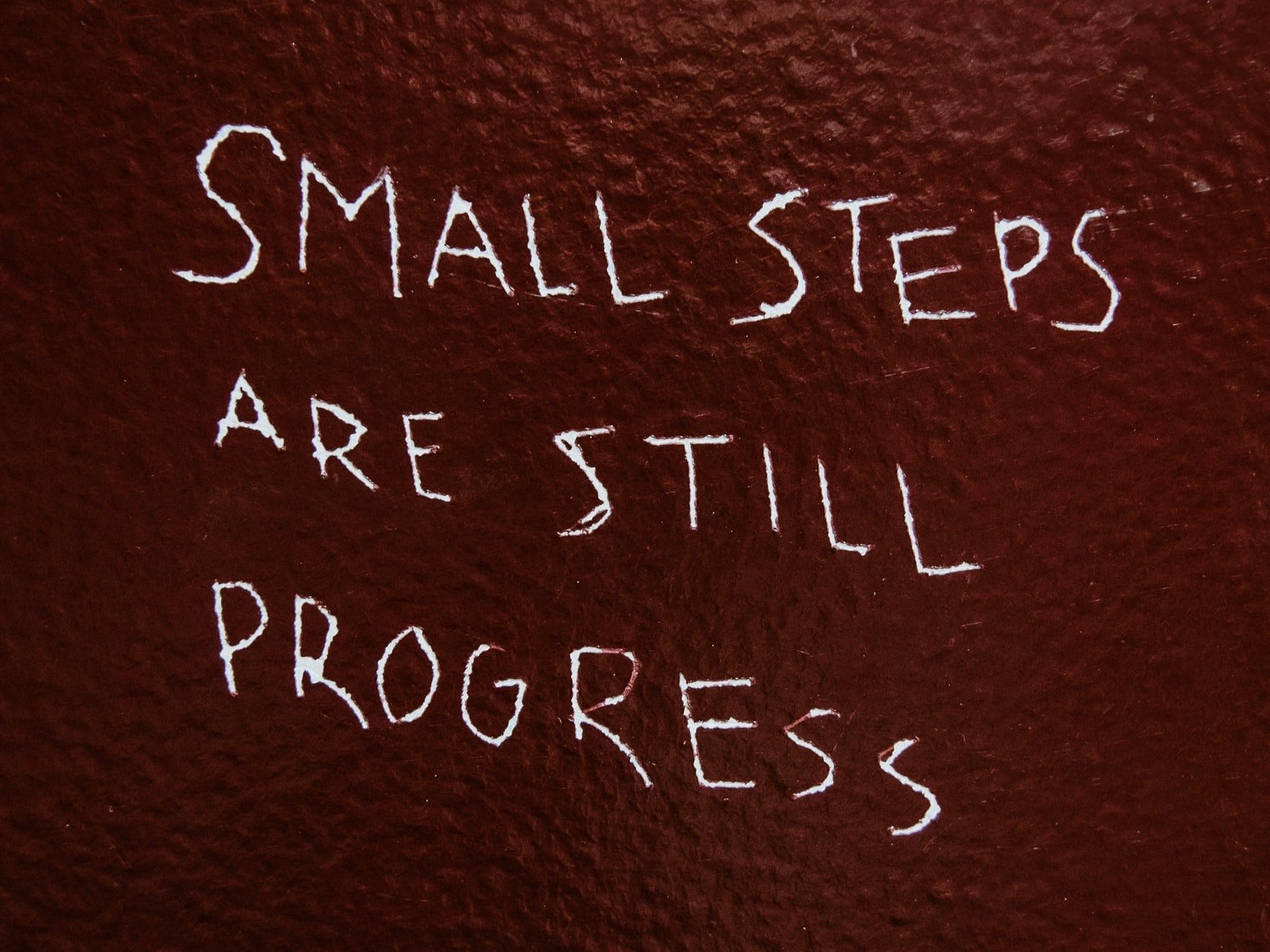 "Small steps are still progress," is inscribed into a painted wall.