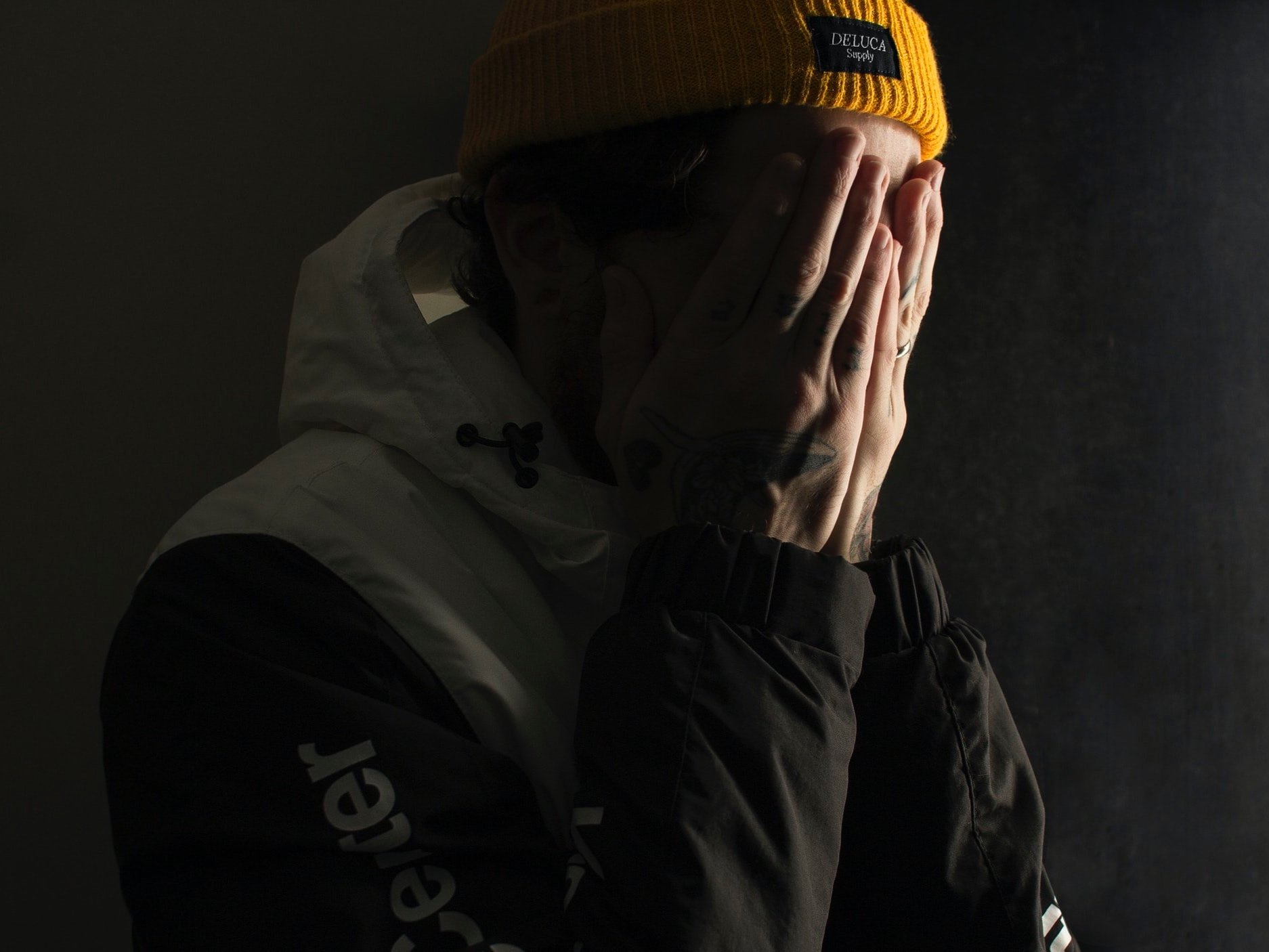 In regret, a man covers his face with his hands.