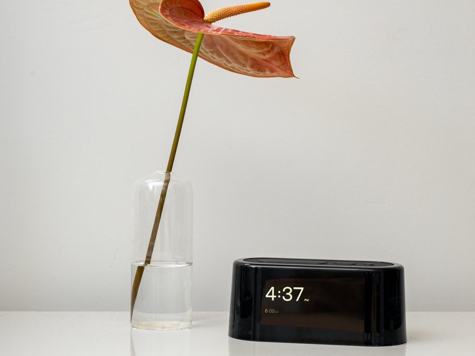A digital alarm clock with a time display and a 6 a.m. alarm setting