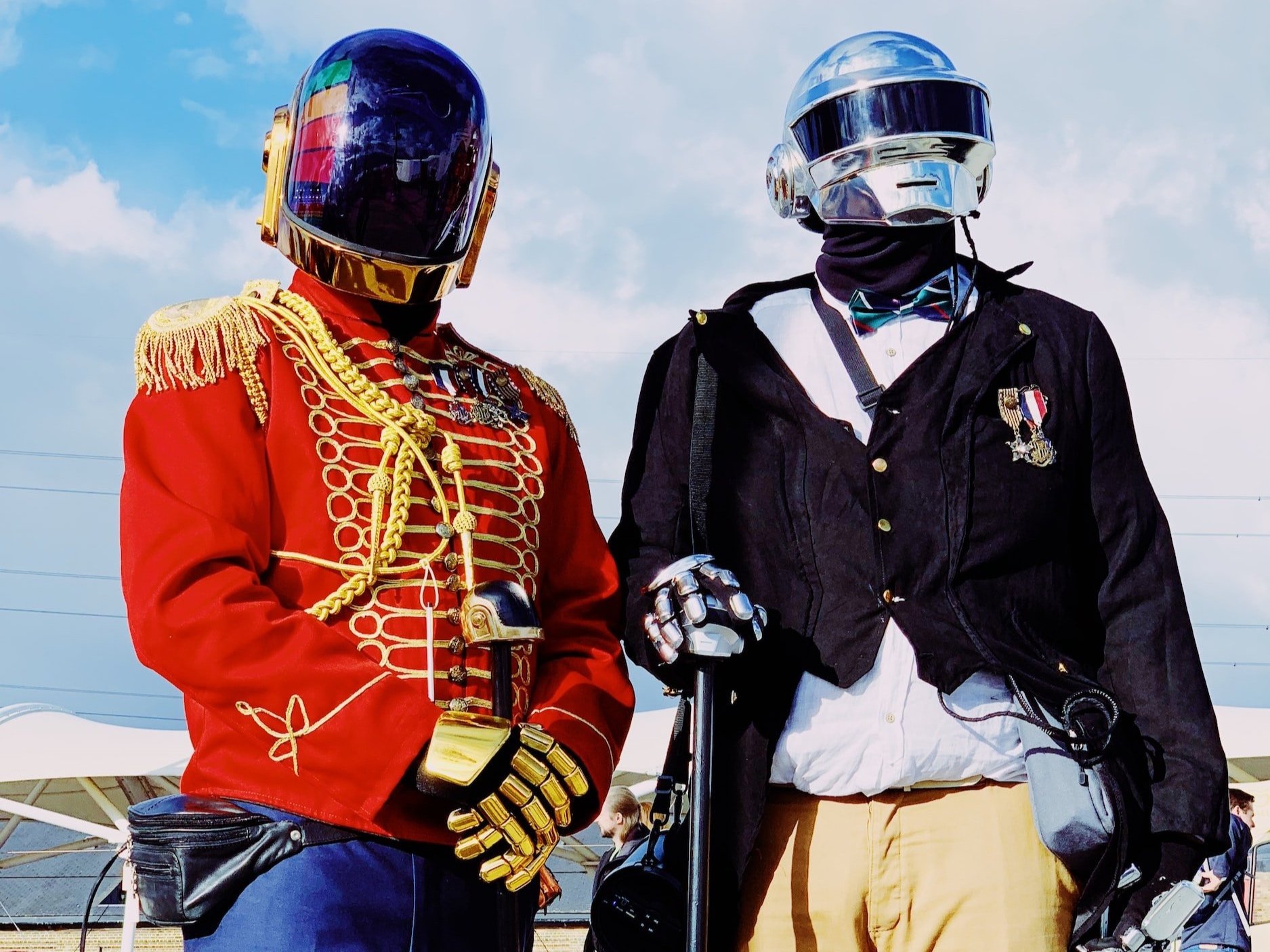 Daft Punk sporting space helmets and strange attire.