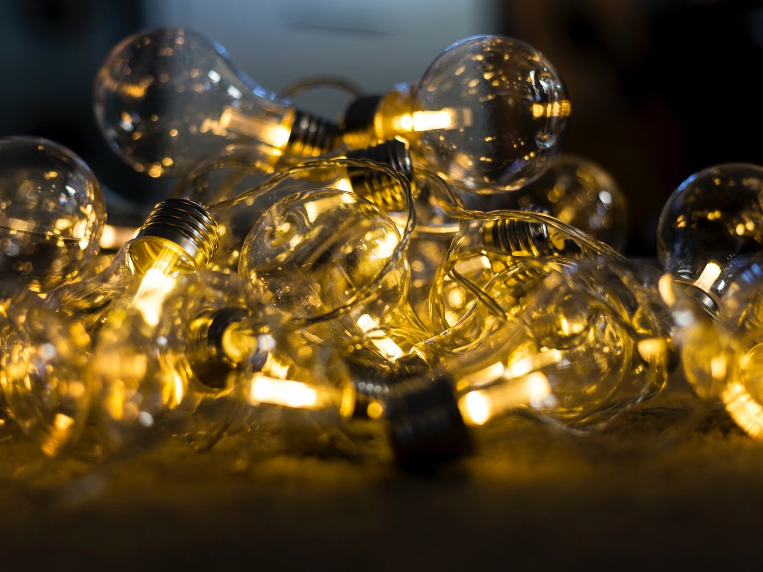 A string of lightbulbs at various degrees of illumination.