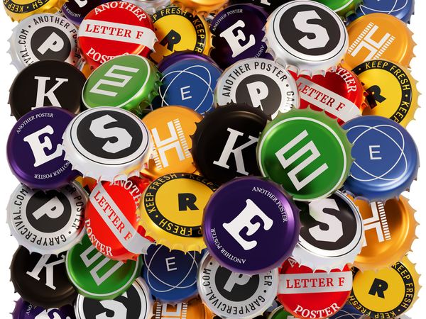 Dense arrangement of colourful bottle caps with bold letters and branding, tightly packed into a graphic, poster-style composition