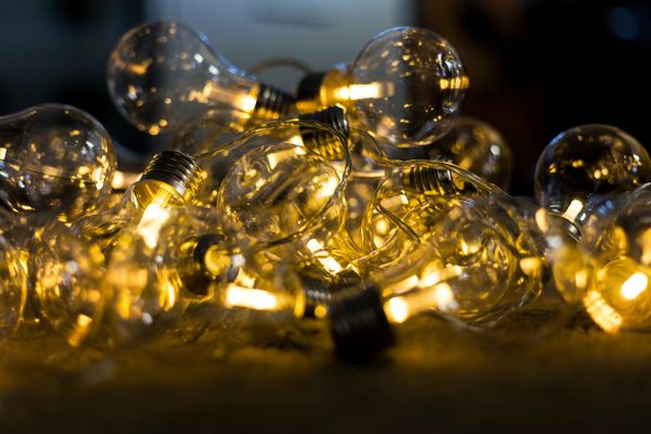 A string of lightbulbs at various degrees of illumination.