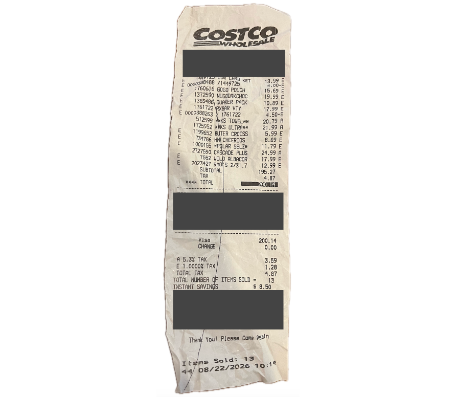A crumpled Costco receipt with personal details blocked out, showing grocery lines in cryptic abbreviations like BUTER CROISS and KS ULTRA, with prices, subtotal, tax, and total.