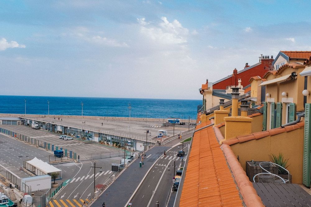 A bright coworking space with desks and a rooftop terrace overlooking the Mediterranean