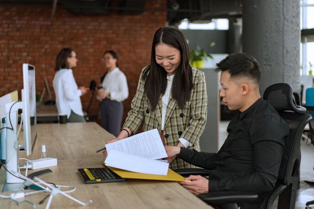 People working at desks in a bright modern coworking office