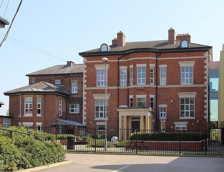 Birkenhead High School Academy; a 19th century red brick mansion that has been converted into a school