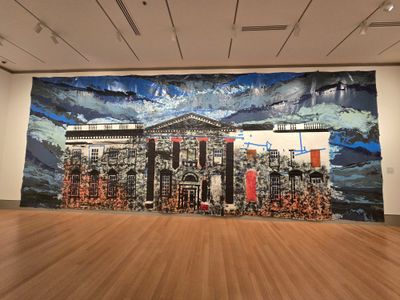 A large painting on paper, of the White House, with dark blue sky, and decaying, ripped front columns in a museum gallery. 