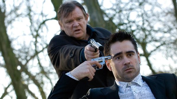 A frame from the 2008 film In Bruges, in which protagonist Ray is holding a gun to his own head, while behind him, his partner Harry holds a gun to Ray's head. 