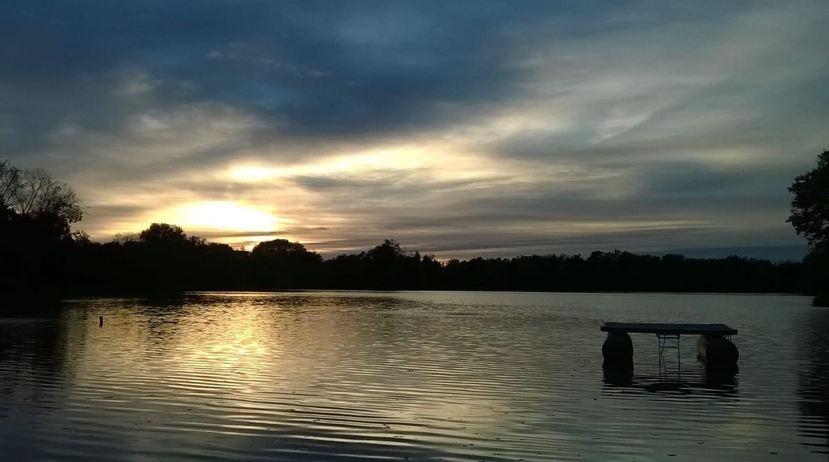 Sunset over a lake, symbolizing the overwhelming presence of water in a flooded basement.
