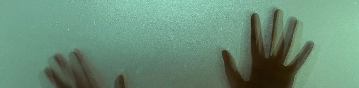 Silhouette of hands, with a ghostly effect from multiple exposures.