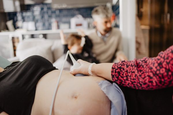 A parent having a private pregnancy scan at Sneak-A-Peek Ultrasound.