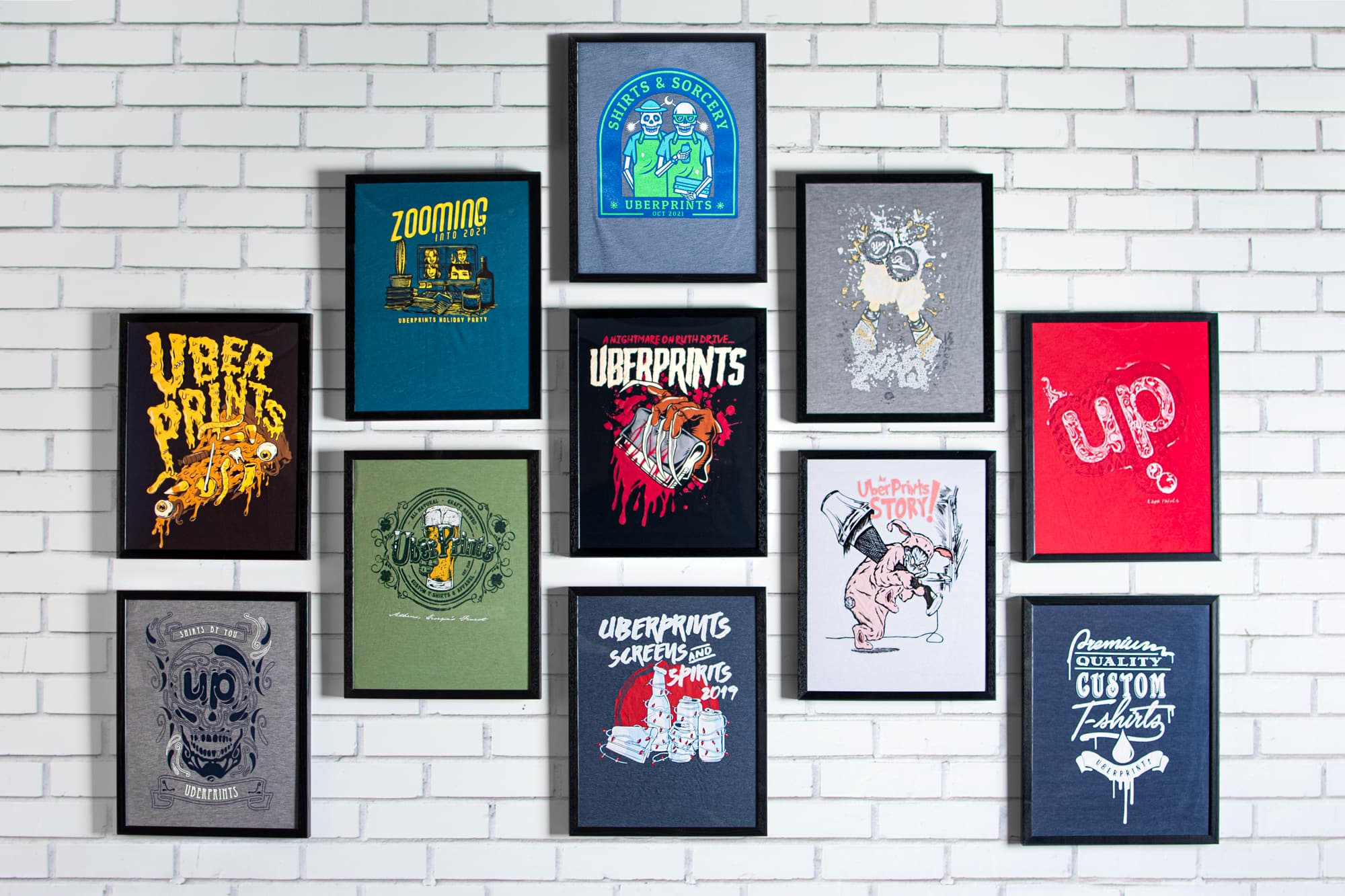 The UberPrints Holiday Shirt Wall. Pictured is the full line of holiday shirts over the years with the new addition of our Shirts & Sorcery Halloween 2021 shirt.