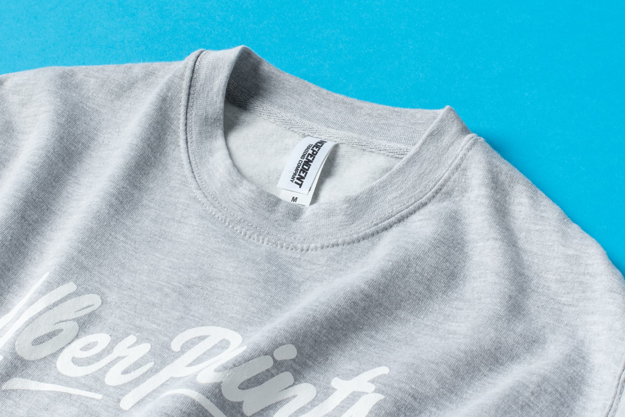 Detail of the Premium Crewneck's collar and tag to show material