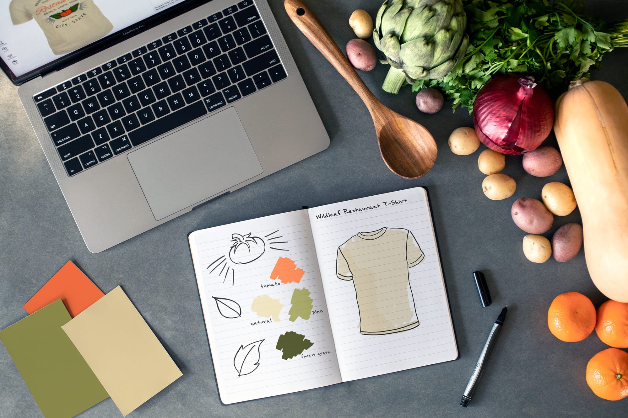 A topdown image of a business owner that is in the planning and design stage of creating their custom shirts.