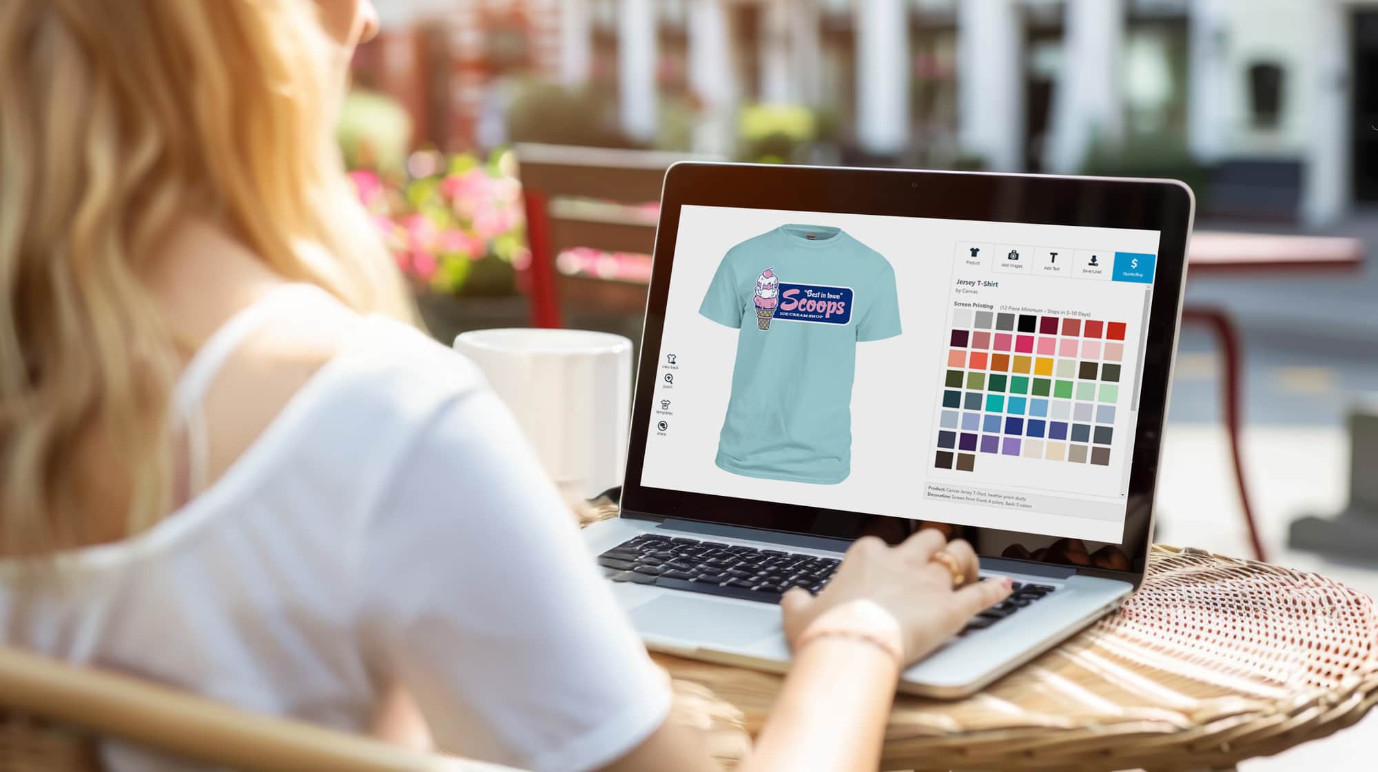 Image of a person on a laptop designing a t-shirt in the UberPrints design studio