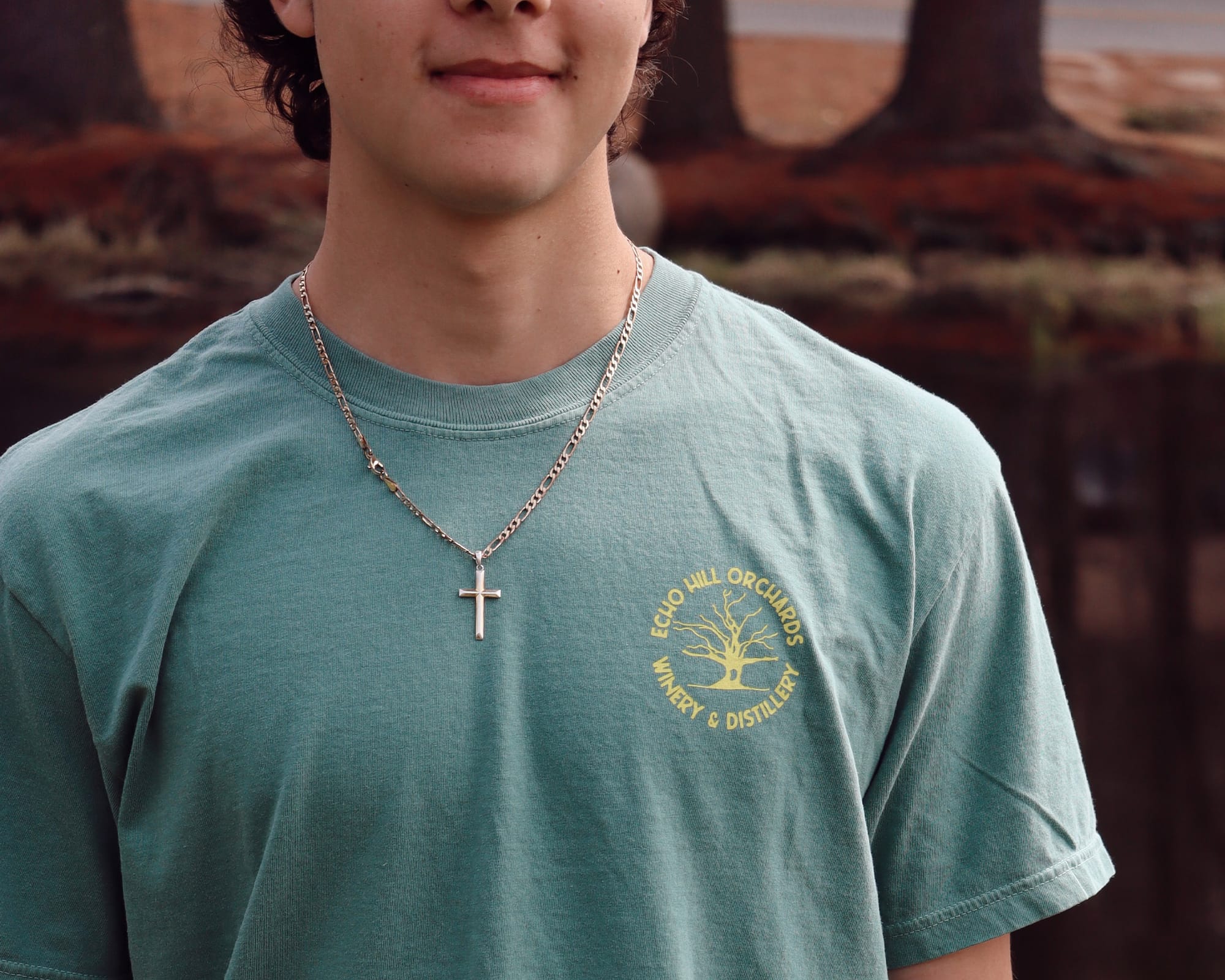 Image of a person wearing an Echo Hill Orchards branded shirt that has a front left chest design of their company logo.