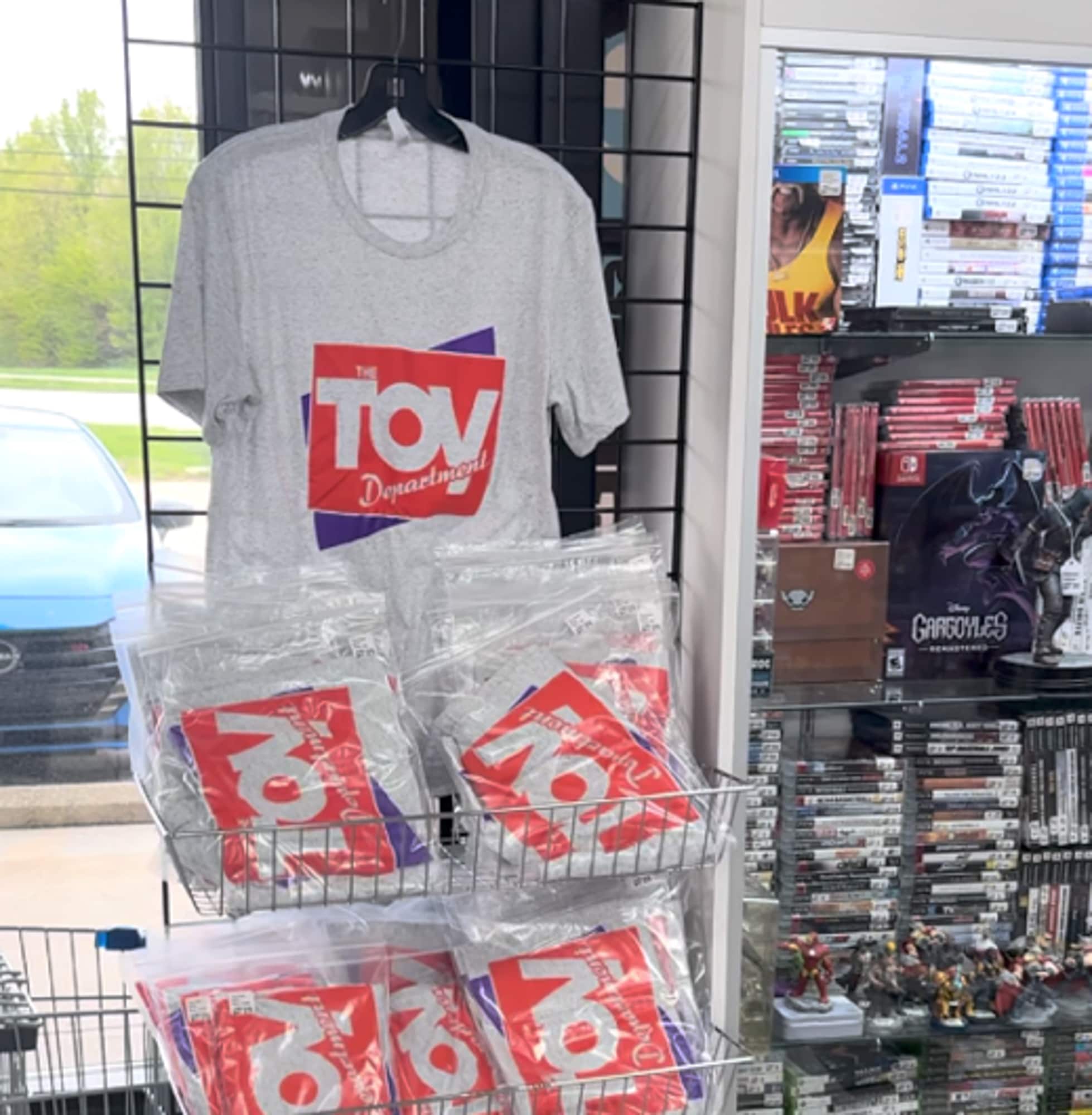 T-shirt display rack near merchandise.