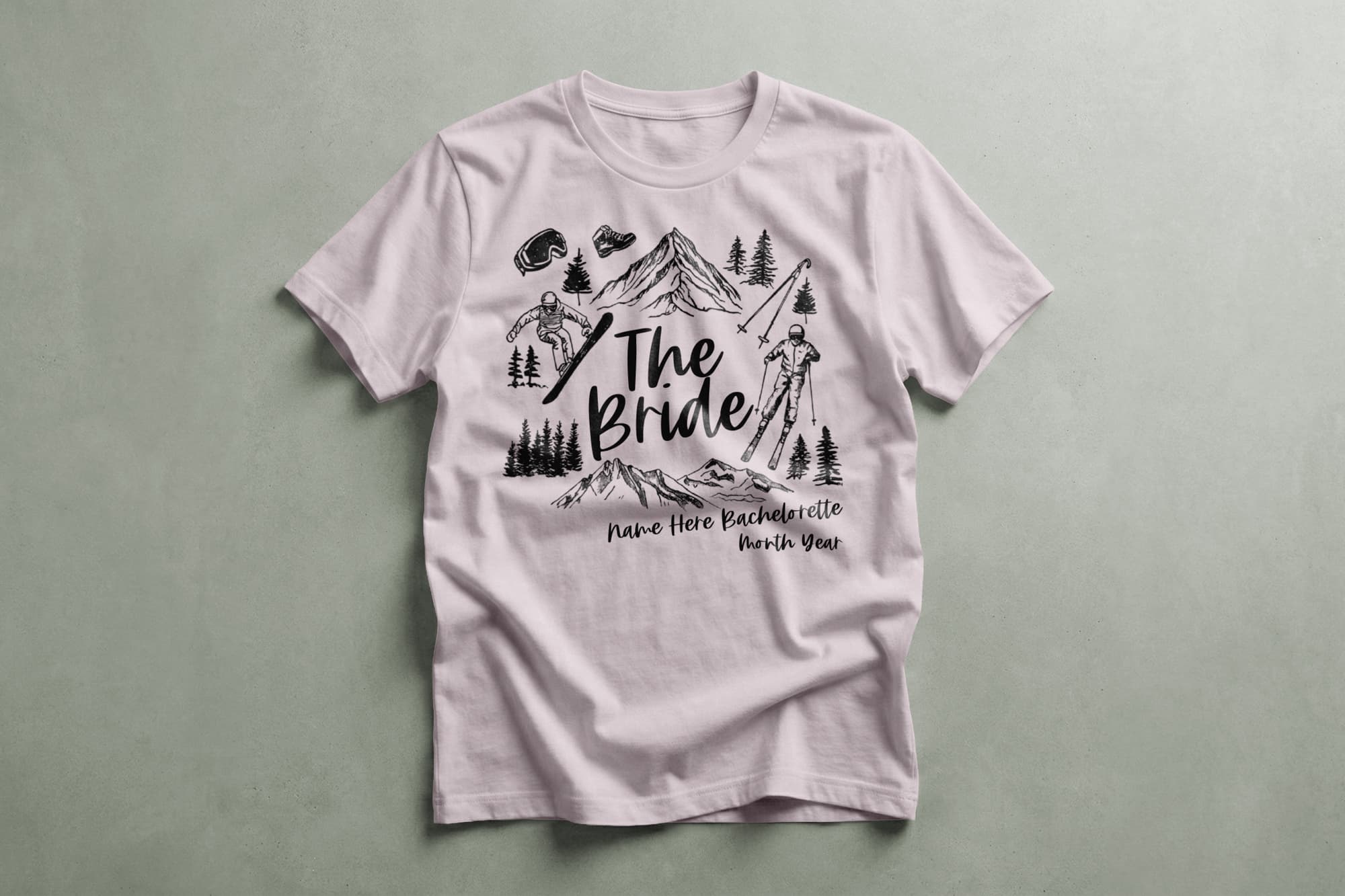 T-shirt with "The Bride" and mountain design, featuring skiing scenes, trees, and customizable text for a bachelorette party. Casual and adventurous theme.