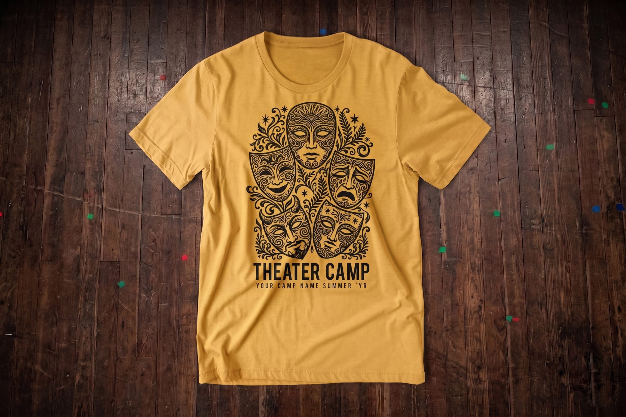 Gold crewneck t-shirt with a black screen-printed theater masks illustration and 'Theater Camp' text below