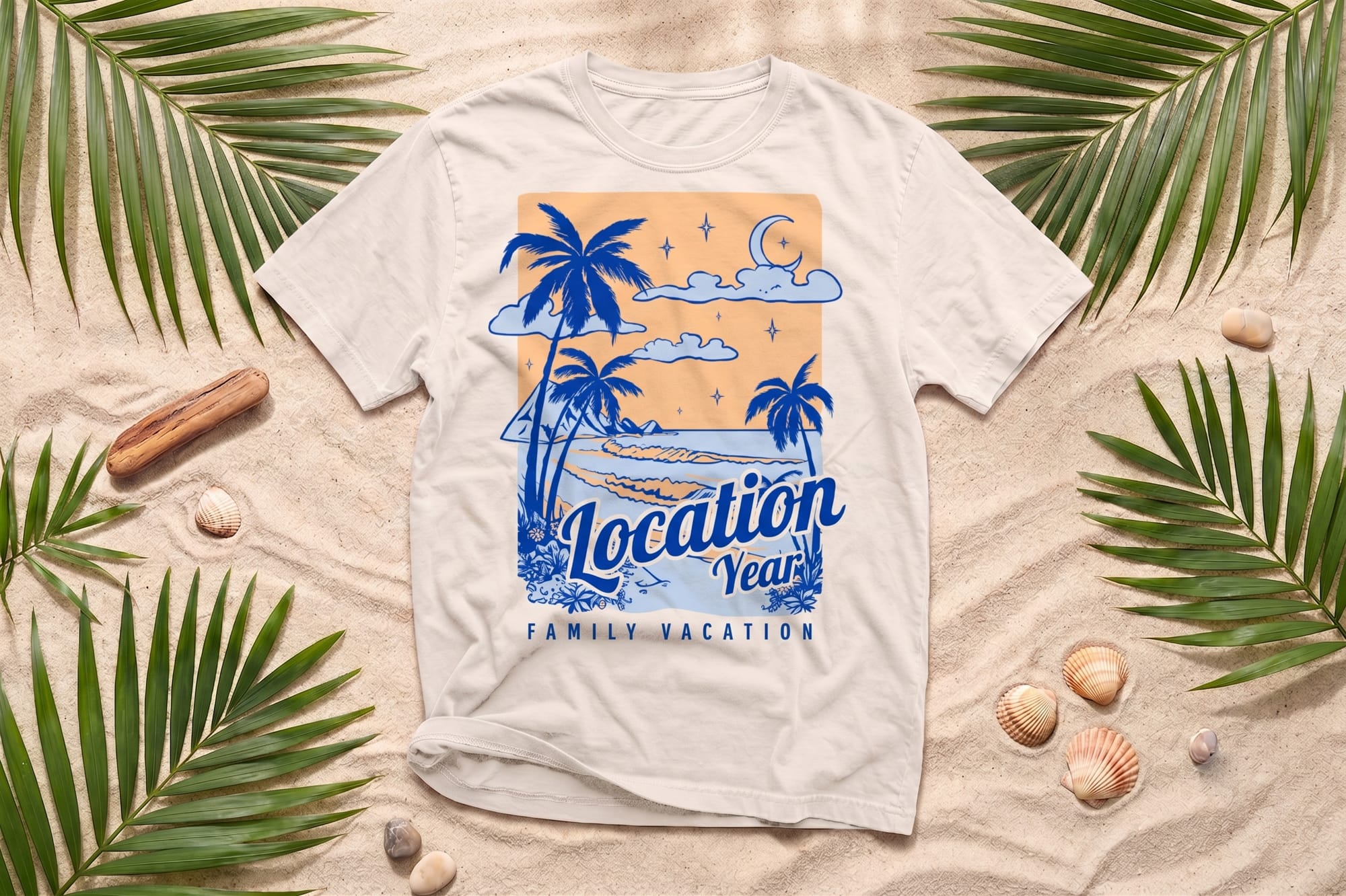 White crewneck t-shirt with a blue retro beach scene print reading 'Location Year Family Vacation,' laid flat on sand