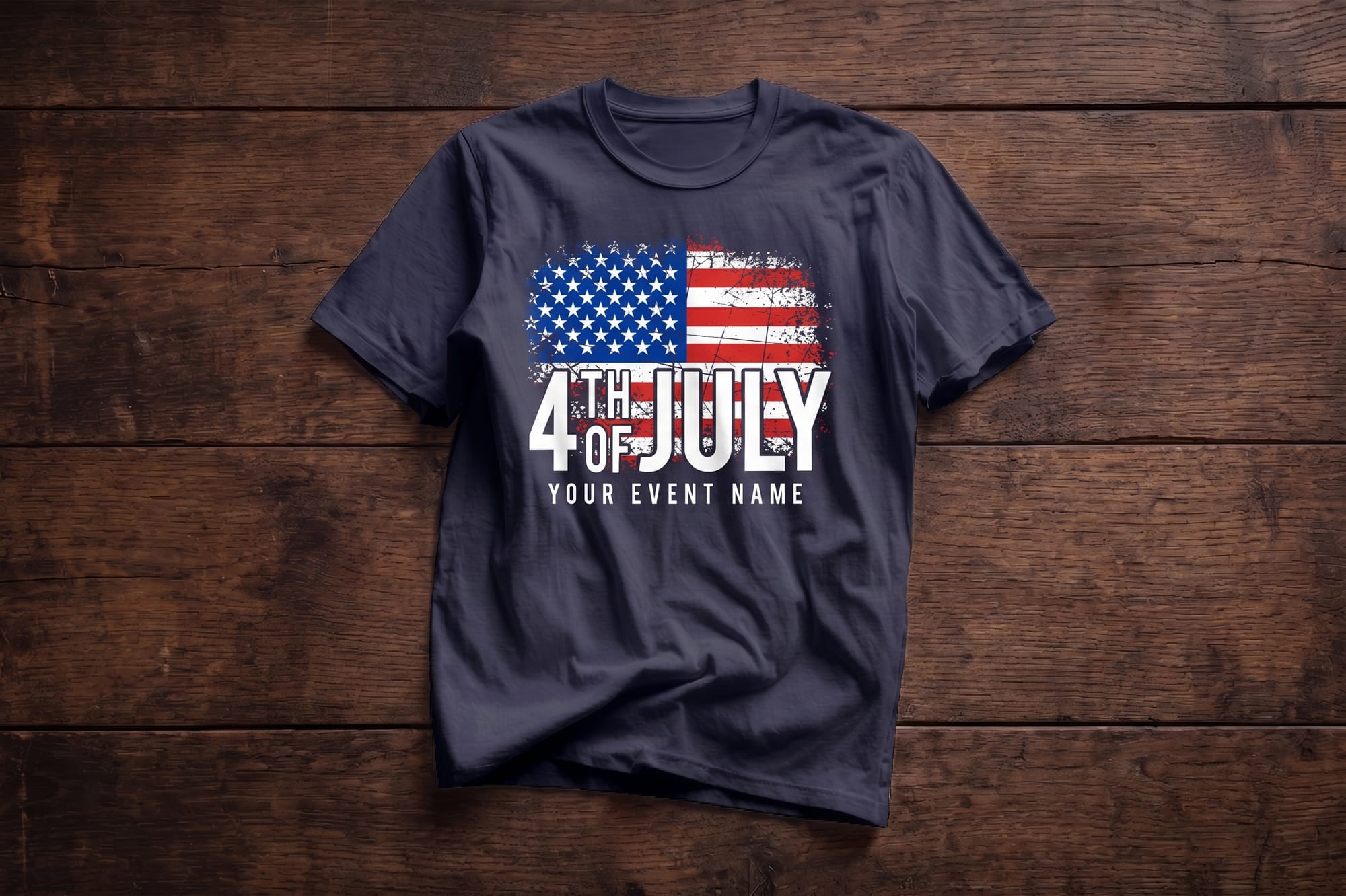 Navy crewneck t-shirt with a distressed American flag and bold '4th of July' custom event text, flatlay on wood