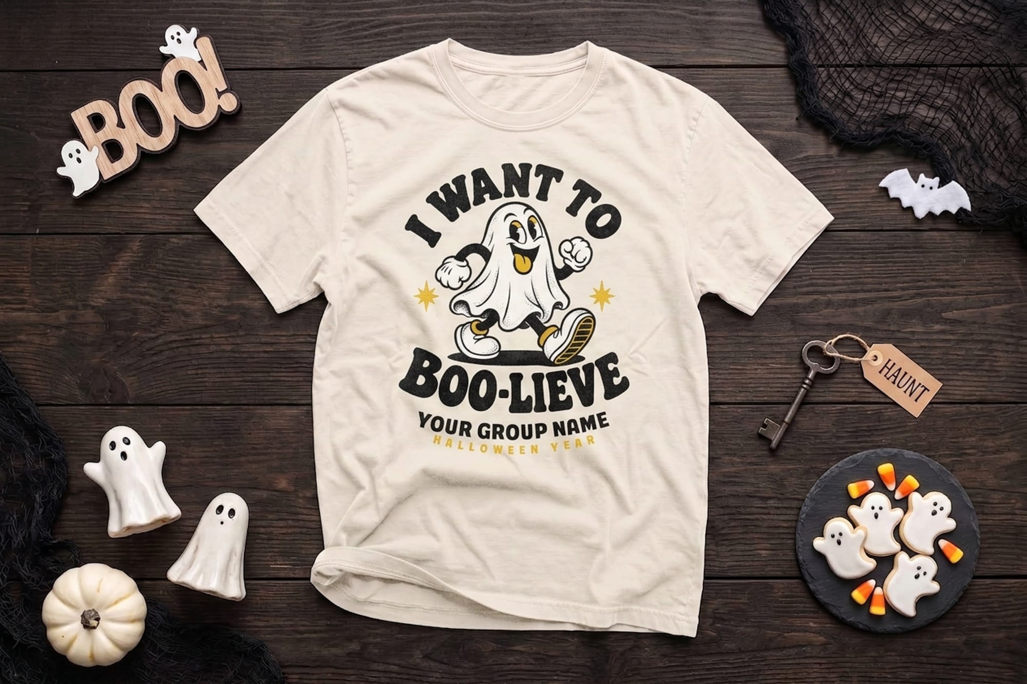 mockup of a halloween flatlay shirt. design is of a ghost and it says want to boo-lieve