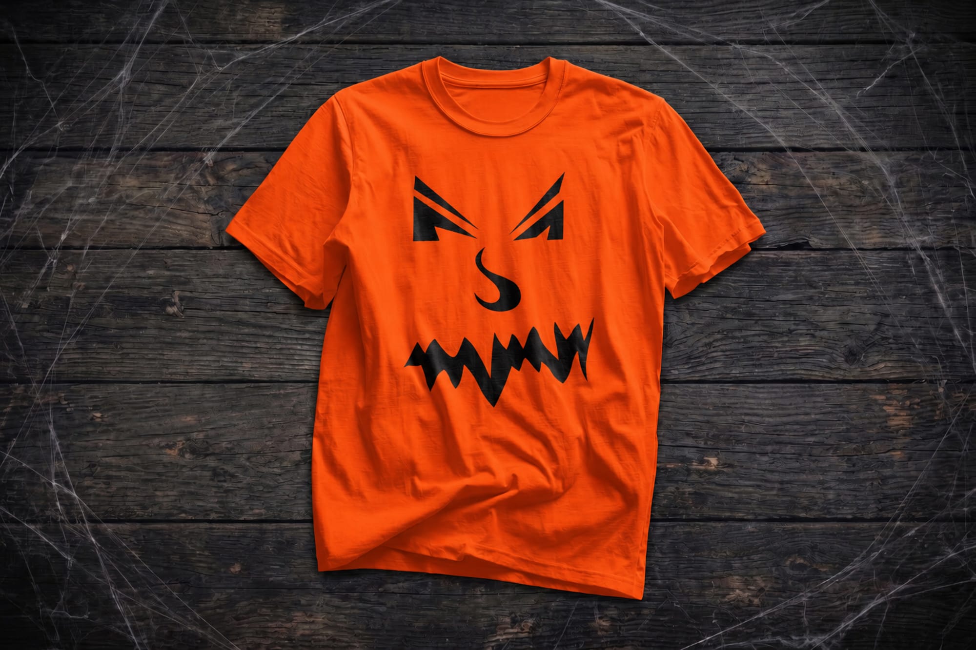 Orange t-shirt template with a black jack-o'-lantern face across the chest
