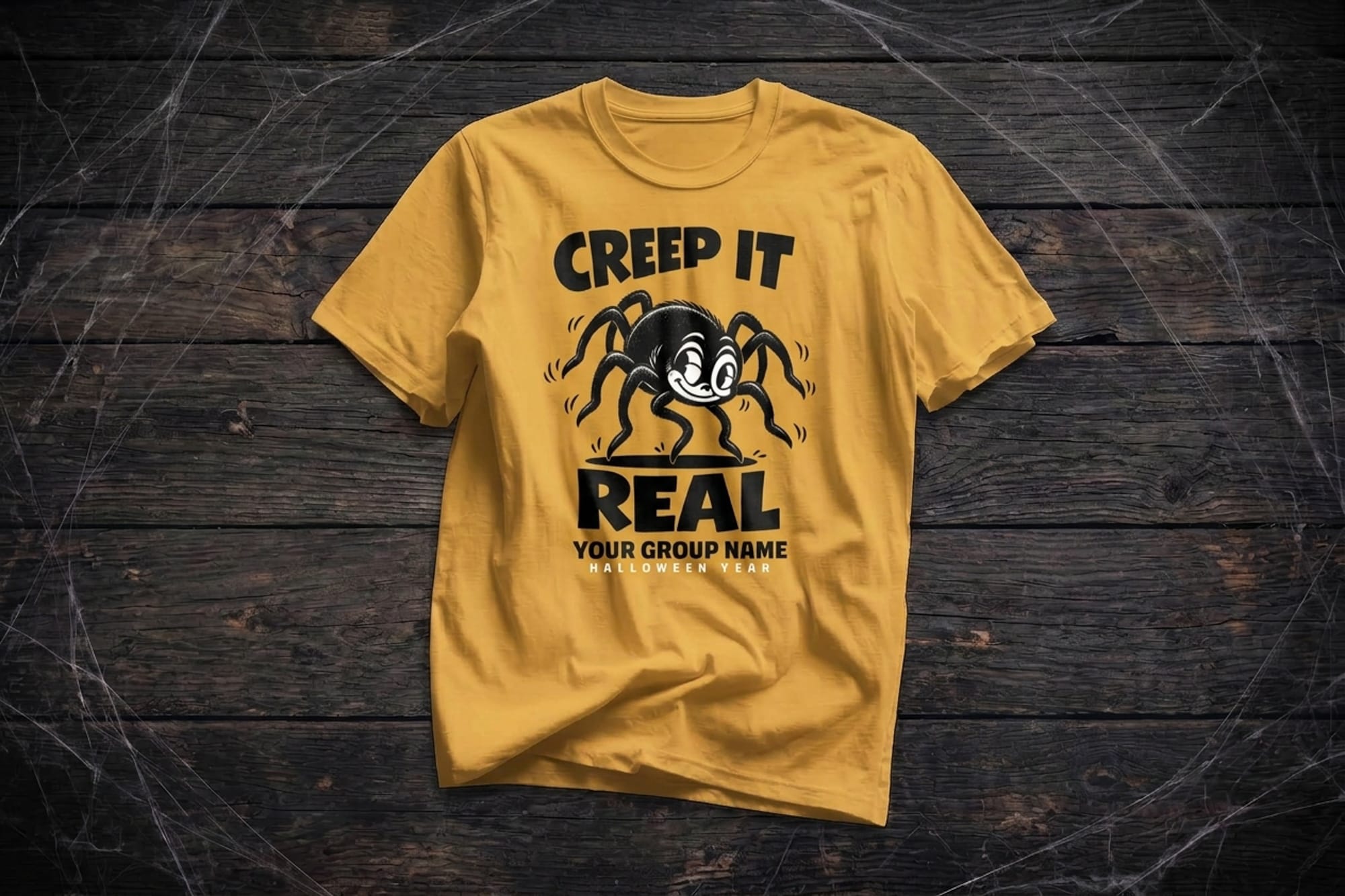 mockup of a halloween flatlay shirt. design is of a spider and it says creep it real