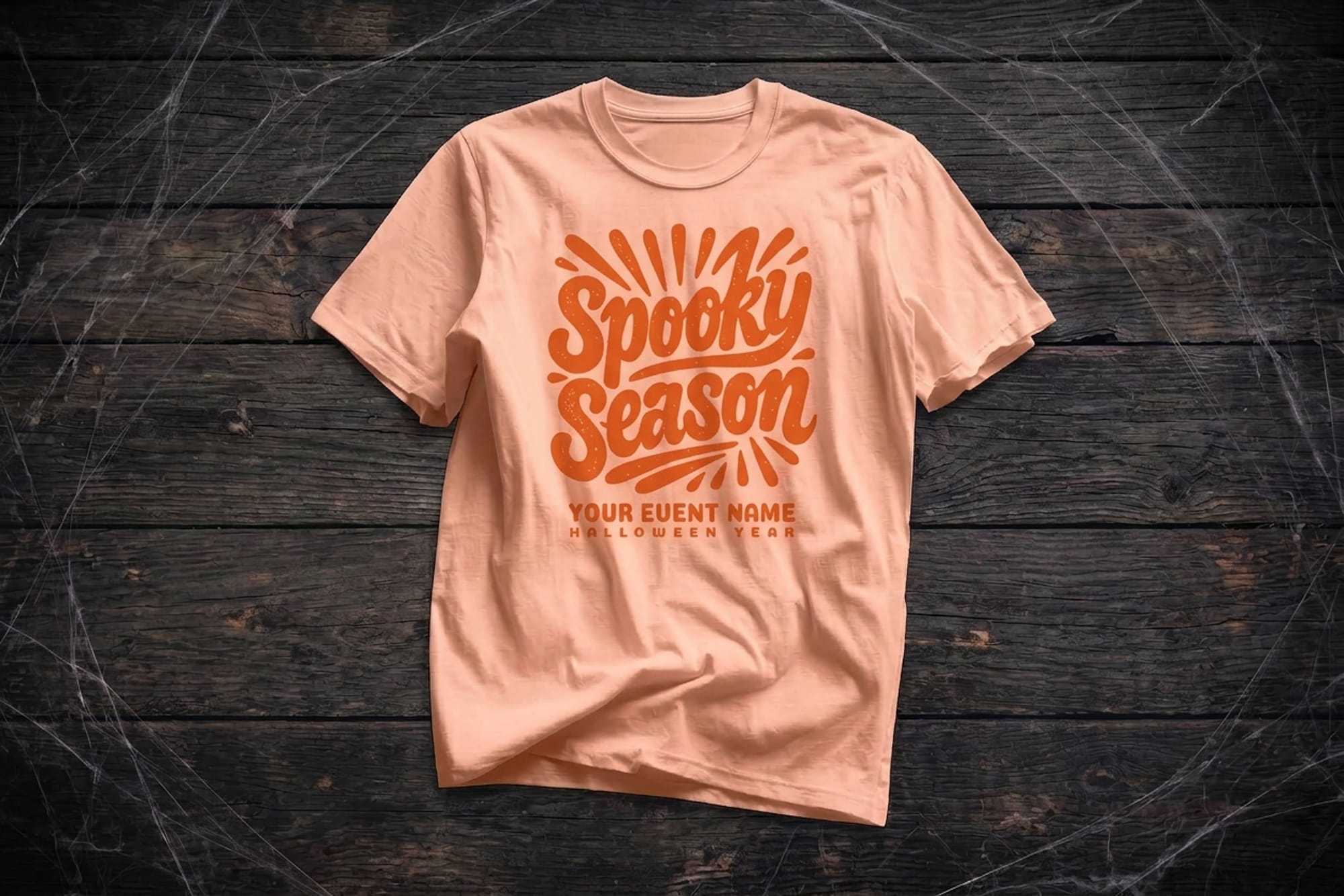Peach t-shirt template with retro orange Spooky Season lettering and editable event name and year