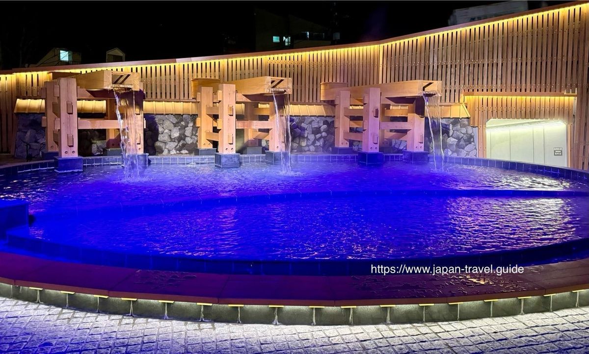 草津温泉之门夜间的蓝紫色灯光与水池