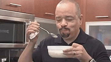 Ice-T eating and dancing in a kitchen