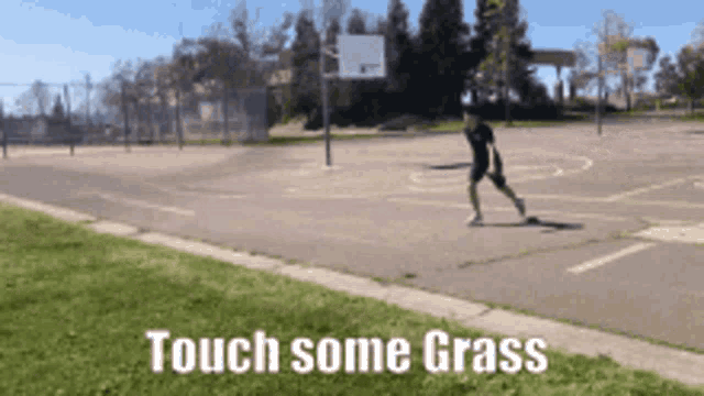 a person diving onto a grass field and rolling around on it