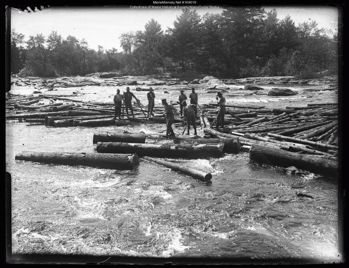 A historical photograph of river drivers on the Saco River in Maine.