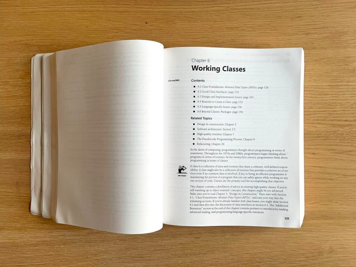 A picture of a copy of Code Complete on a wooden table, open to Chapter 6.