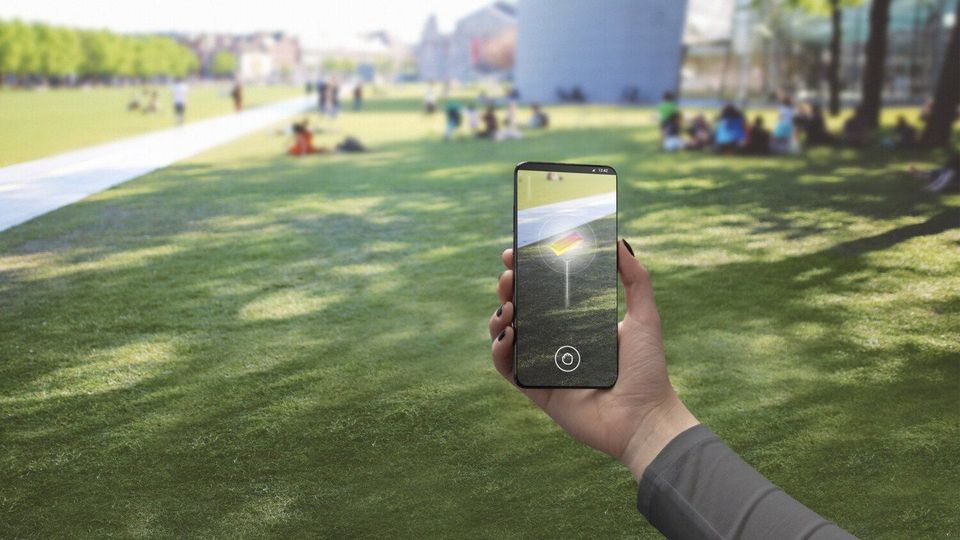 Ericsson photo of person using 5G mobile phone for augmented reality application.