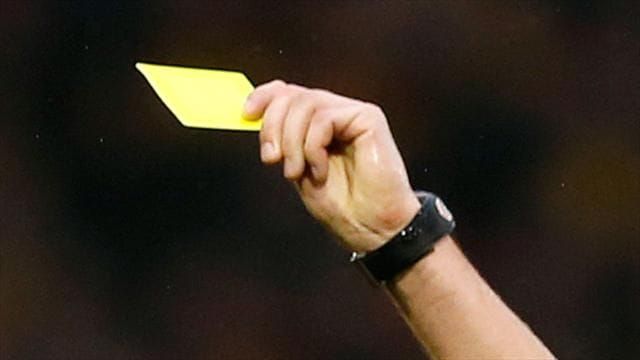 Referee giving a yellow card. 