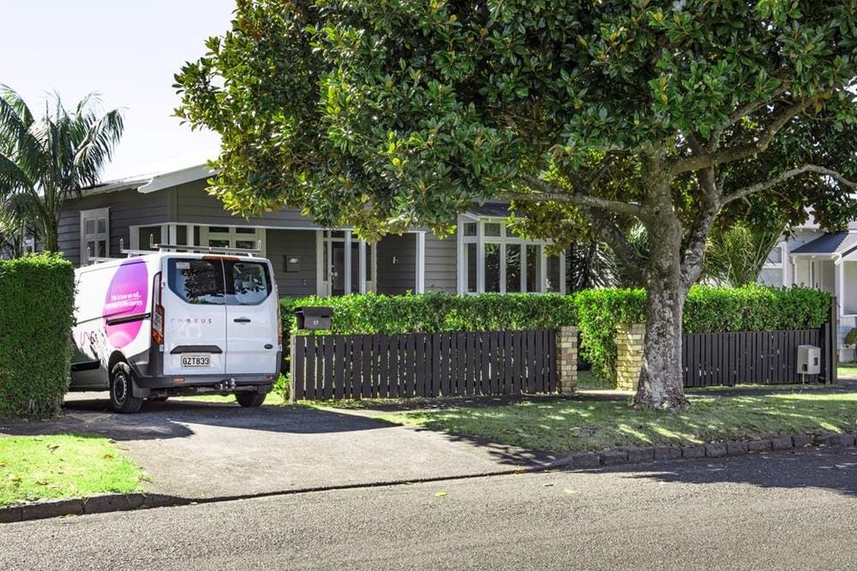Chorus van parked in drive way of typical suburban New Zealand house. 
