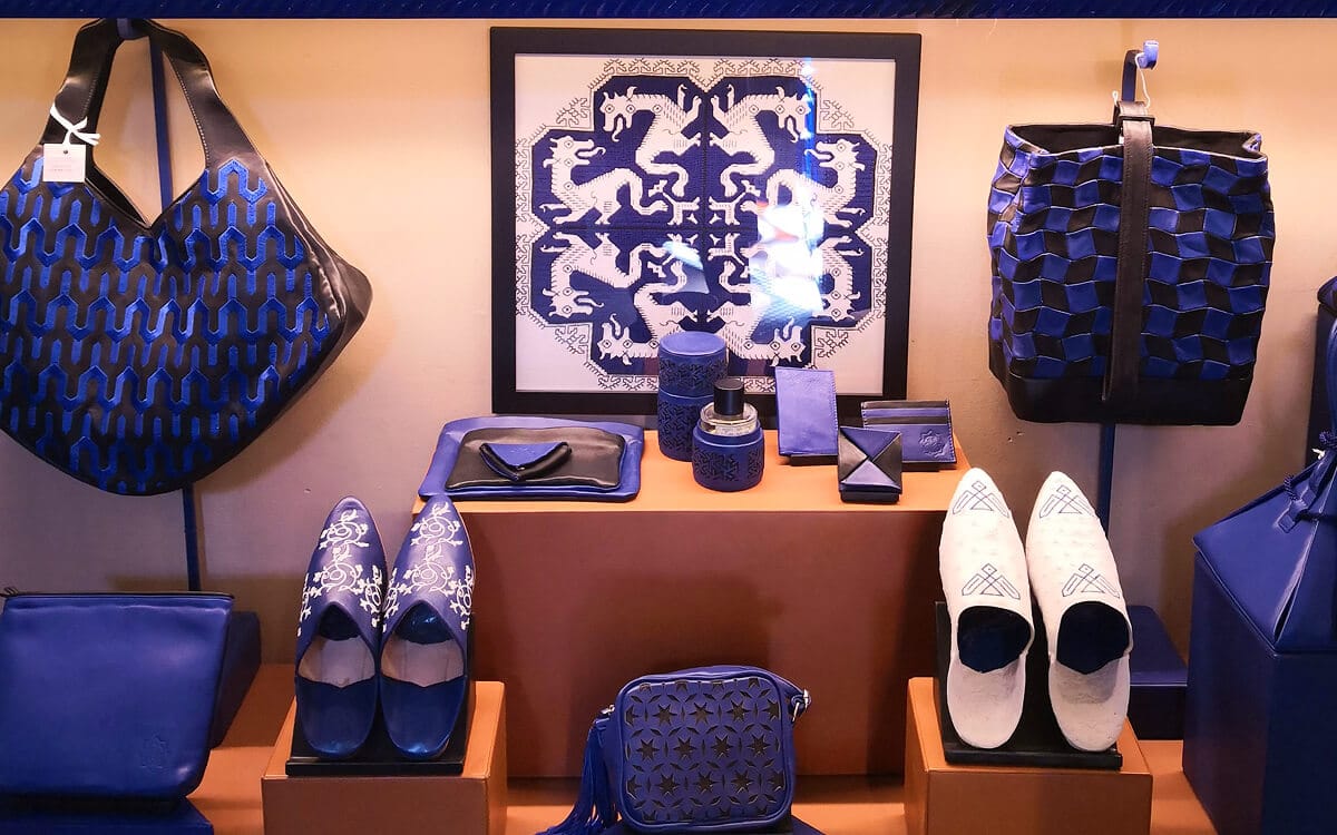 Blue leather bags, shoes, and accessories displayed in the Jardin Majorelle shop, inspired by geometric patterns and Moroccan design