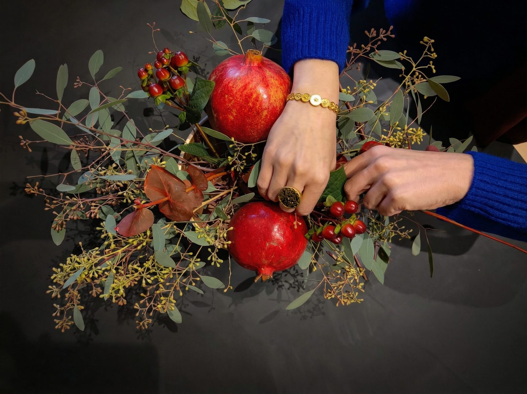 Neda adjusting the pomegranate flower arrangement for Yalda