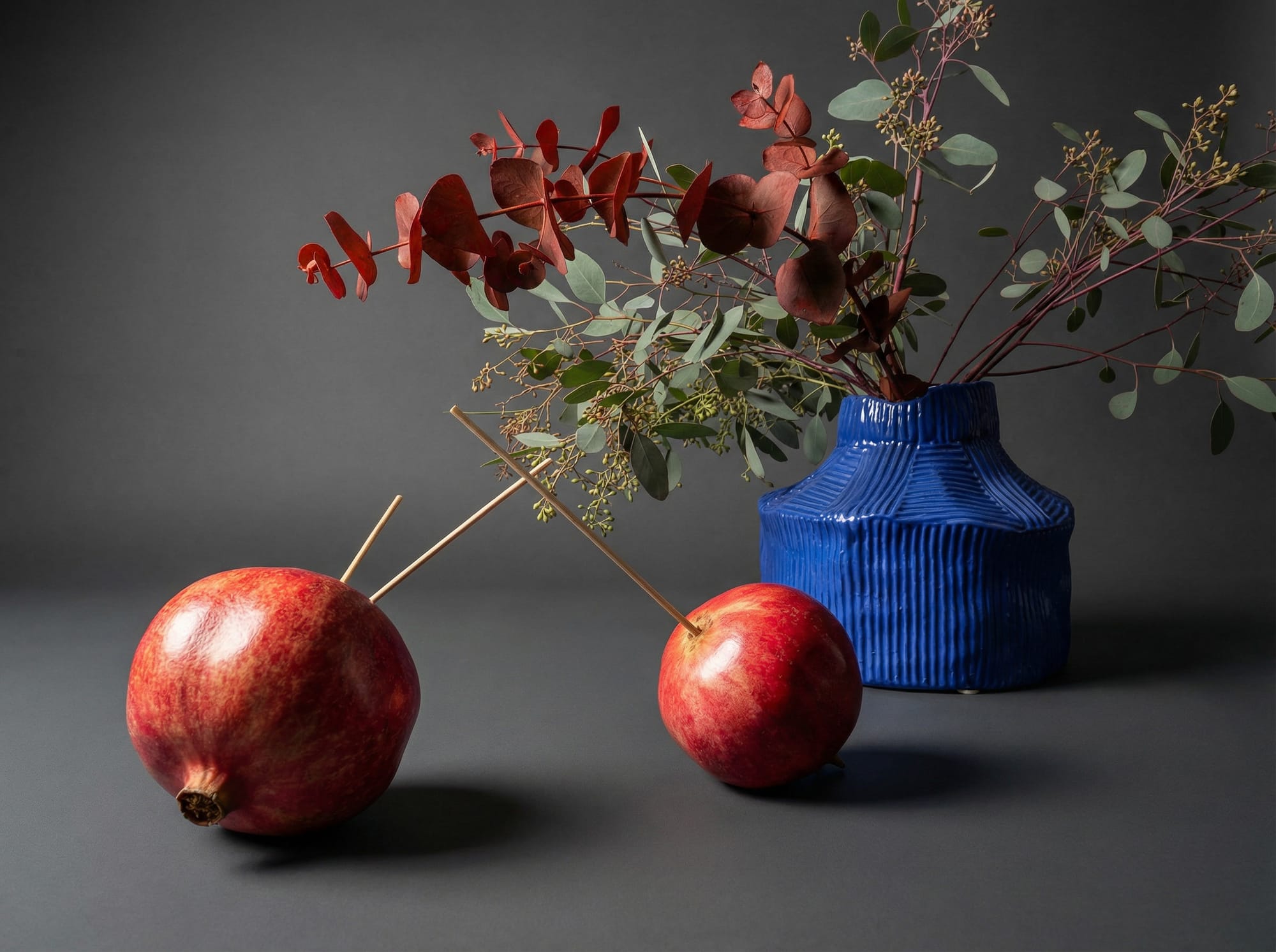 How to secure the pomegranates with wooden sticks for the centerpiece