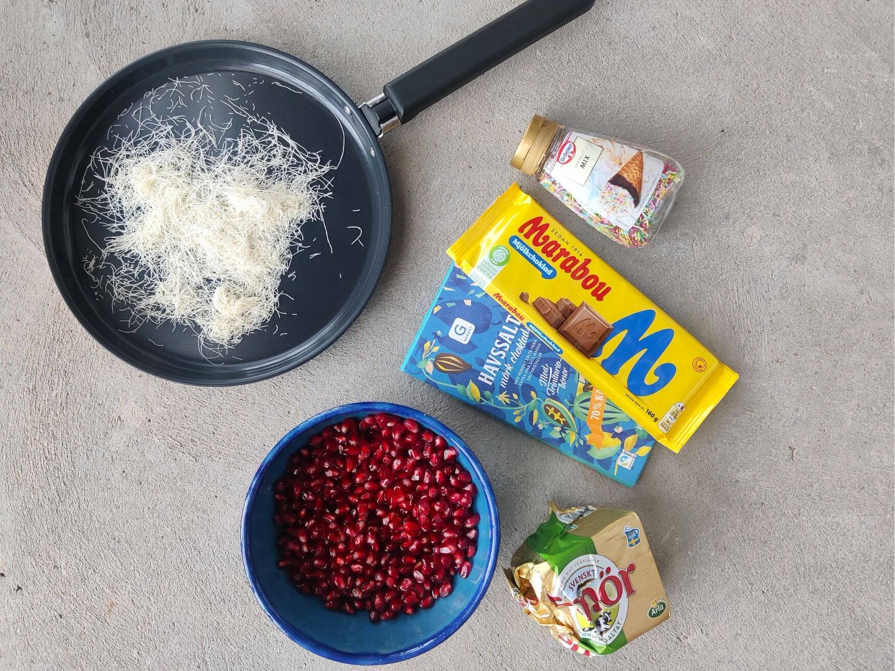 Ingredients for no-bake pomegranate chocolate bites on countertop