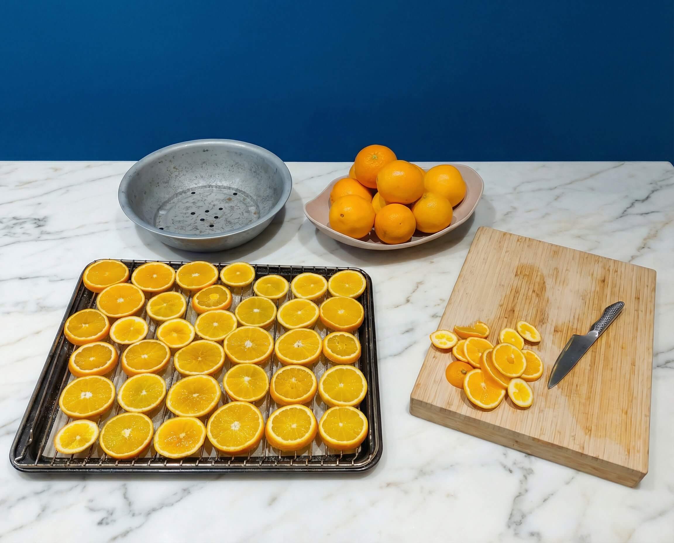 Slicing fresh oranges for a DIY orange bowl centerpiece.