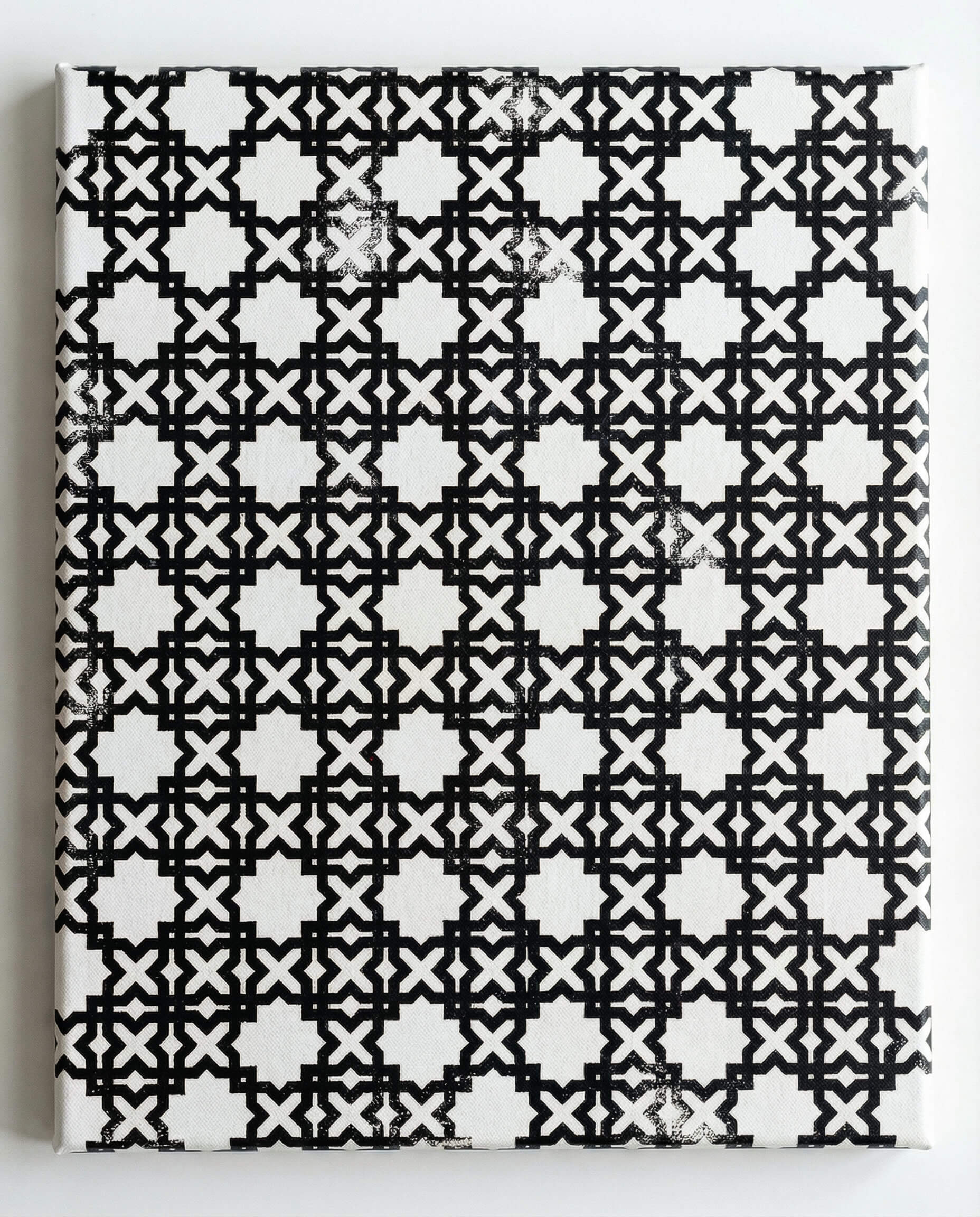 Islamic geometric artwork created with stamps on canvas, showing layered patterns used as contemporary wall art