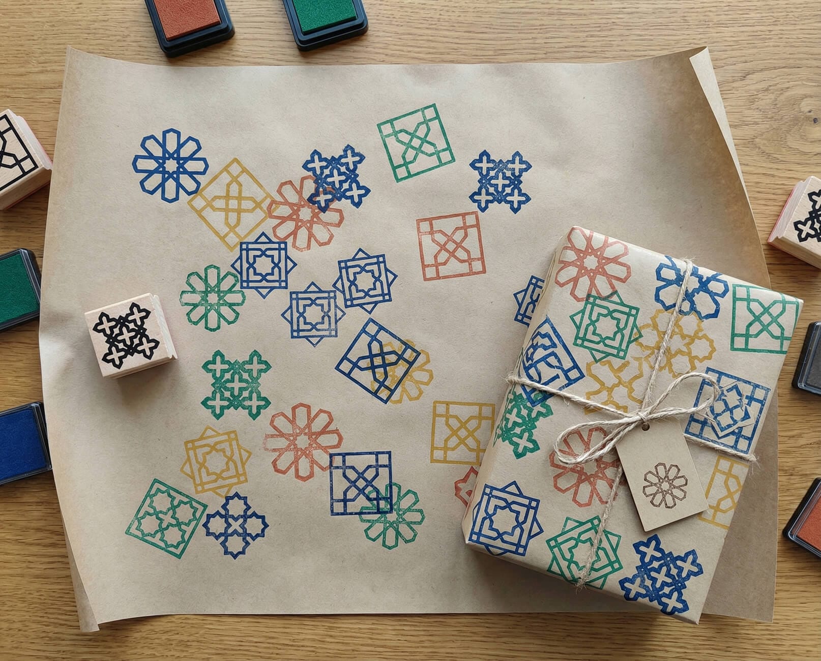 Hand-stamped wrapping paper decorated with colourful Islamic geometric patterns, used as a sustainable Ramadan DIY project for kids.