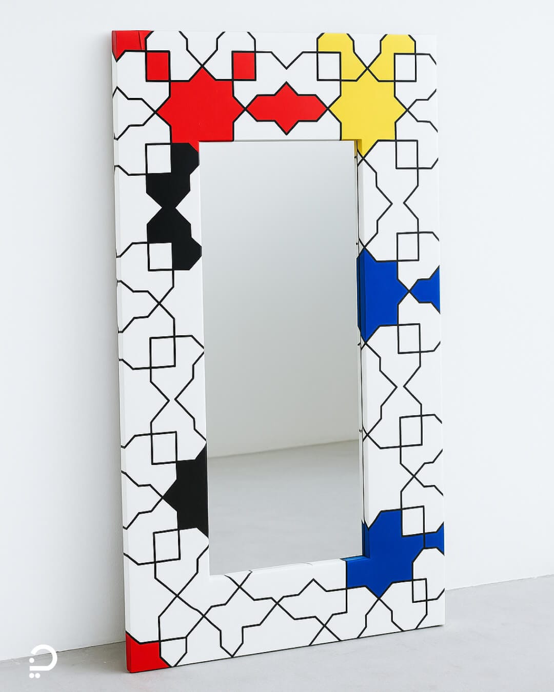 Modern geometric mirror inspired by Islamic patterns, featuring primary colours and structured line work in a contemporary interior